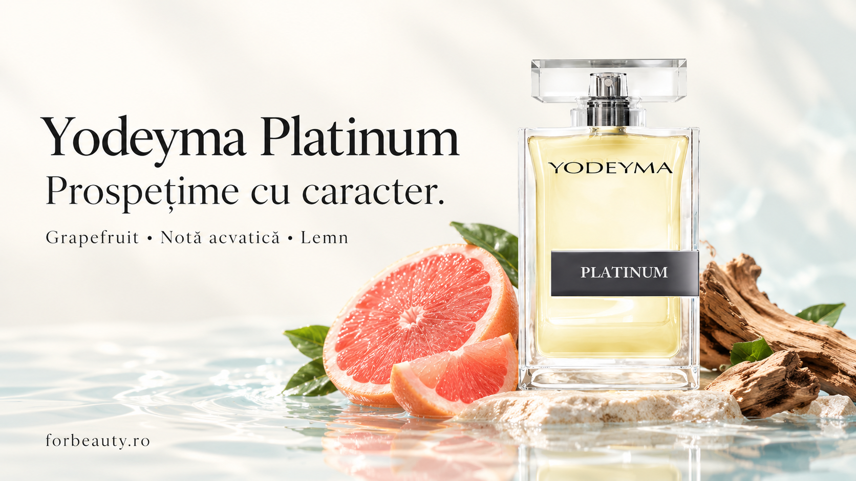 Flacon Yodeyma Platinum alături de grapefruit și bucăți de lemn, pe o suprafață cu reflexii de apă.